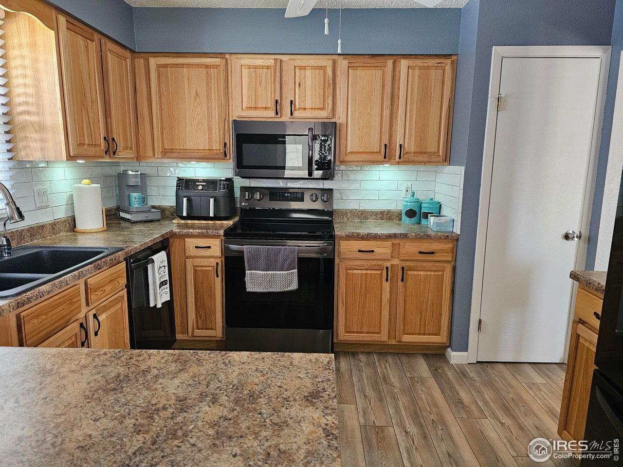 1628 Pheasant Ridge Sterling, CO 80751 - Photo 13 of 40 Bar top in kitchen provides seating along with additional countertop space. Individual lights w/ 4 choices of color under each cabinet.