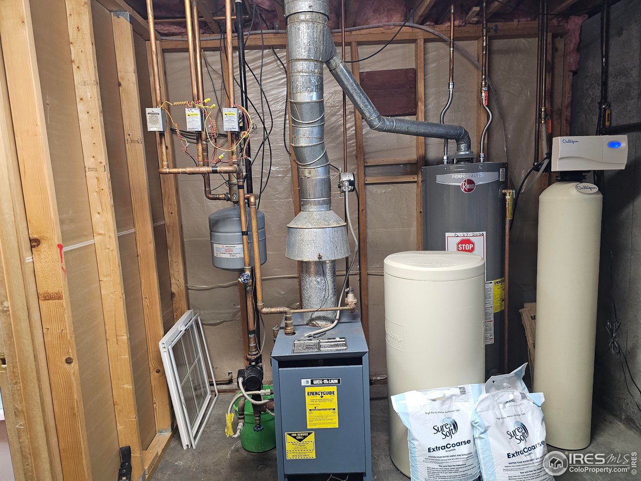 1628 Pheasant Ridge Sterling, CO 80751 - Photo 27 of 40 Basement room housing the hot water heat system, softener and hot water heater is approx 13 x 8 which gives you additional storage room on the south wall.
