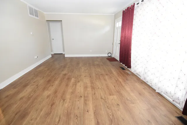 a view of a room with wooden floor
