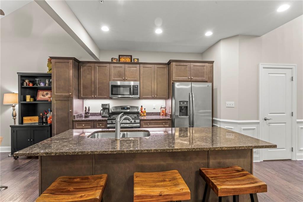 104 Anderson Station Venetia, PA 15367 - Photo 7 of 32 a kitchen with kitchen island granite countertop a sink a stove and cabinets