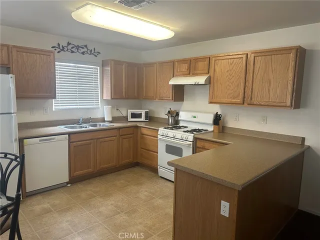 a kitchen with a stove sink and cabinets