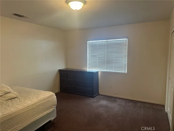 a room with a bed and a window