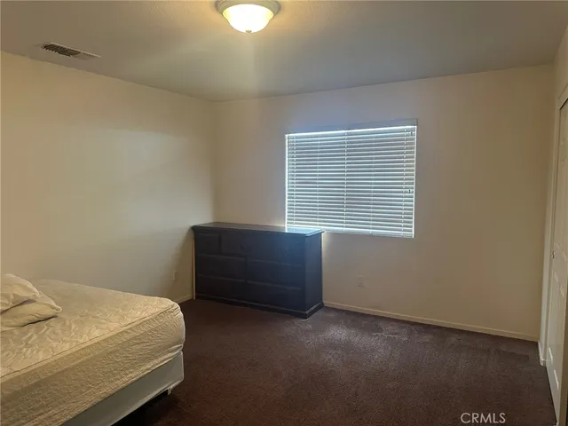 a room with a bed and a window