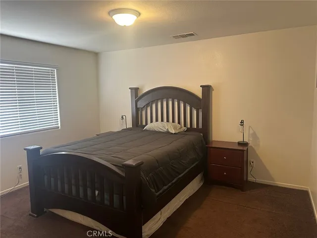 a bedroom with a bed and a table