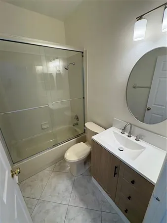 a bathroom with a double vanity sink toilet and shower