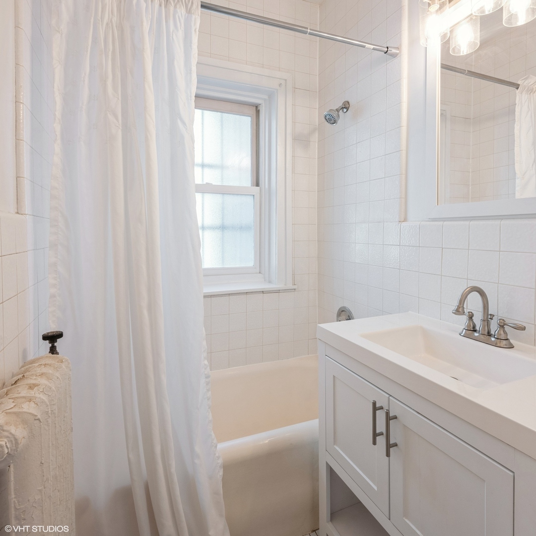 538 West Brompton Avenue, Unit 1W Chicago, IL 60657 - Photo 11 of 16 a bathroom with a sink a toilet and shower