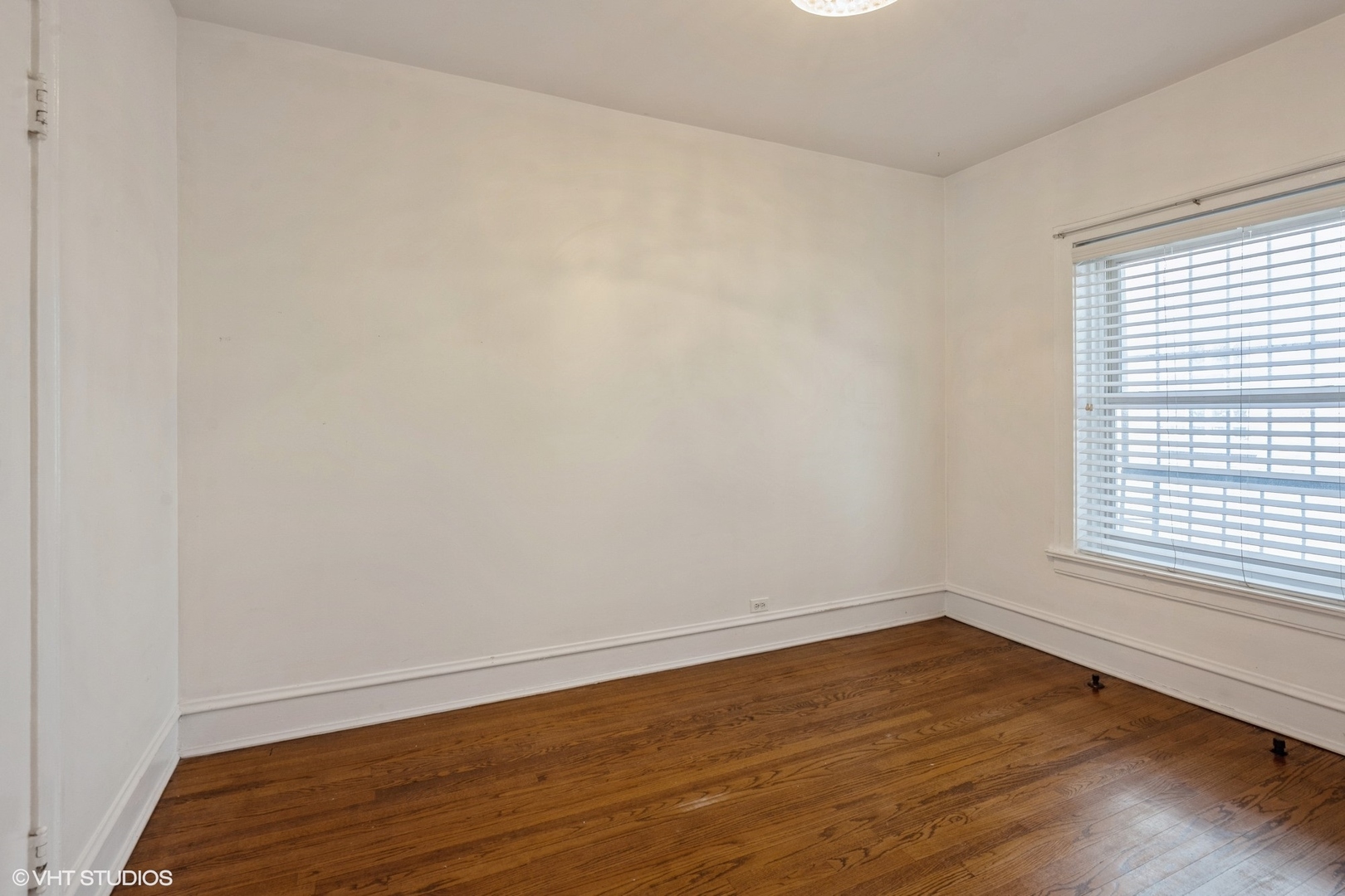 538 West Brompton Avenue, Unit 1W Chicago, IL 60657 - Photo 12 of 16 wooden floor in an empty room with a window