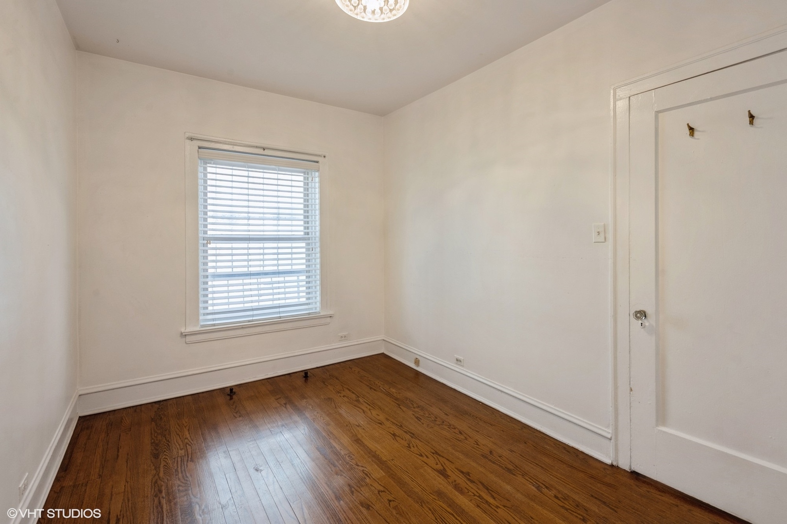 538 West Brompton Avenue, Unit 1W Chicago, IL 60657 - Photo 13 of 16 an empty room with wooden floor and windows