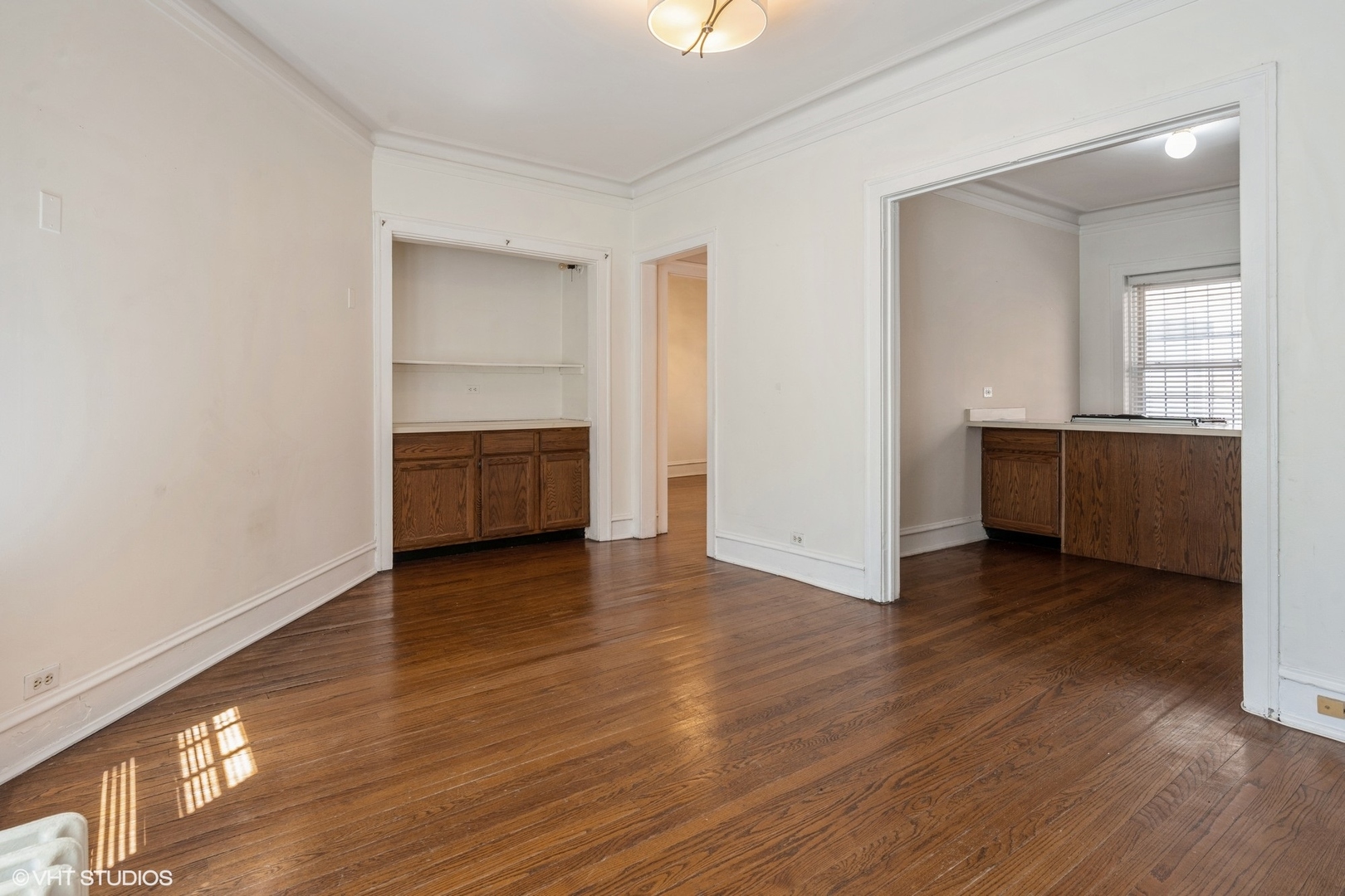 538 West Brompton Avenue, Unit 1W Chicago, IL 60657 - Photo 7 of 16 an empty room with wooden floor cabinet and windows