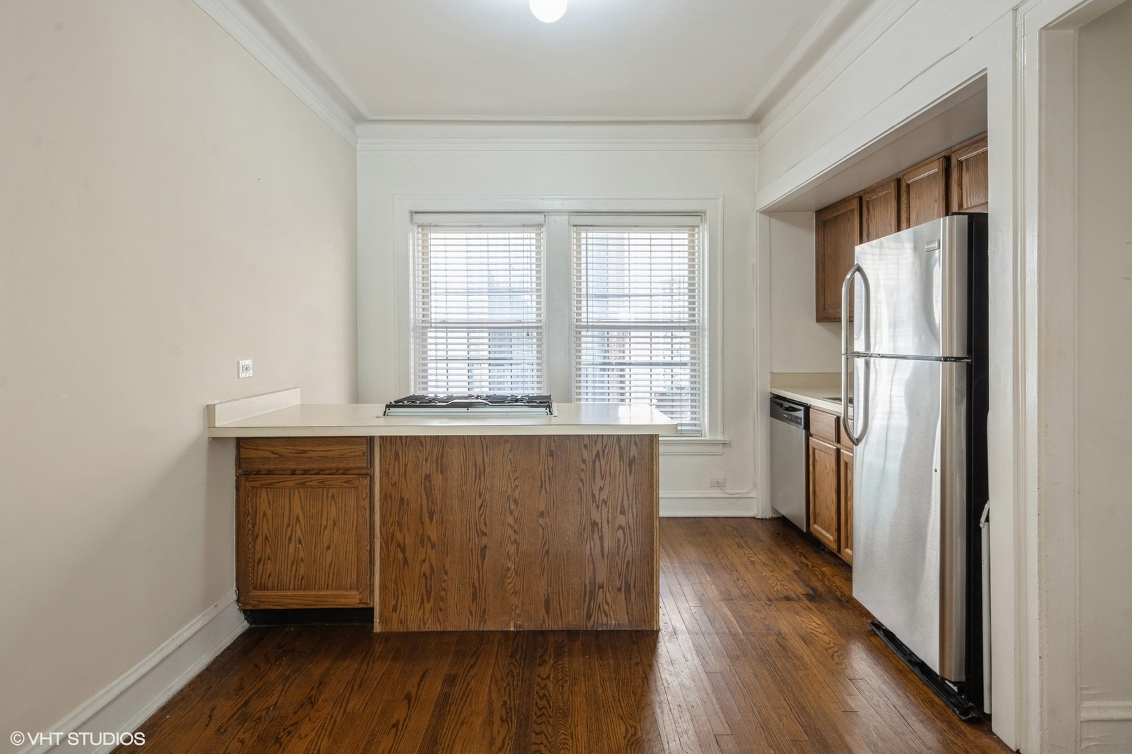 538 West Brompton Avenue, Unit 1W Chicago, IL 60657 - Photo 8 of 16 a kitchen with a refrigerator a sink and wooden floor