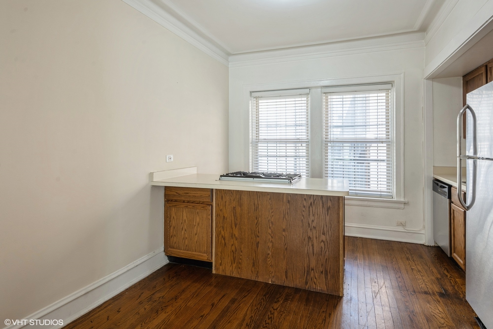 538 West Brompton Avenue, Unit 1W Chicago, IL 60657 - Photo 9 of 16 a view of an empty room with wooden floor and a window