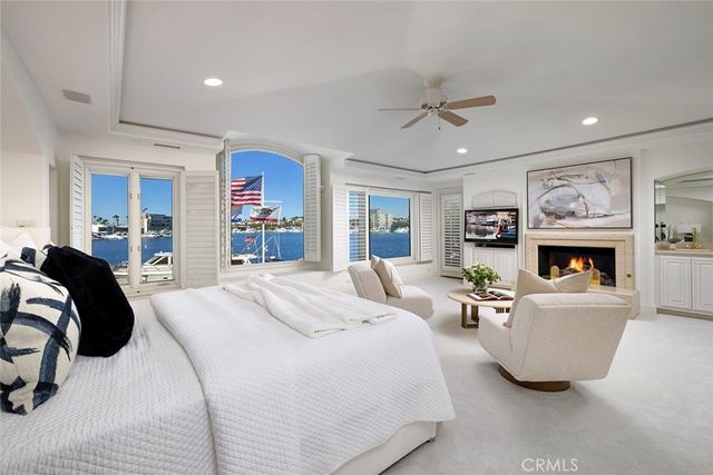 a spacious bedroom with a bed a couch and a window