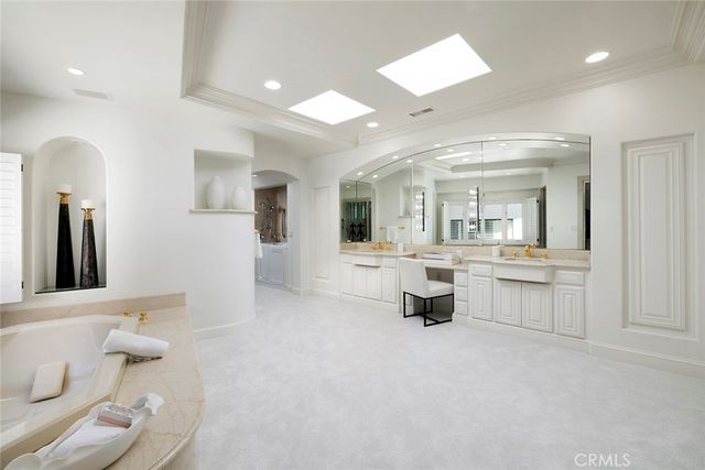 a bathroom with a double vanity sink toilet and mirror