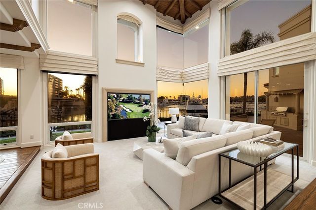 a living room with furniture fireplace and a large window