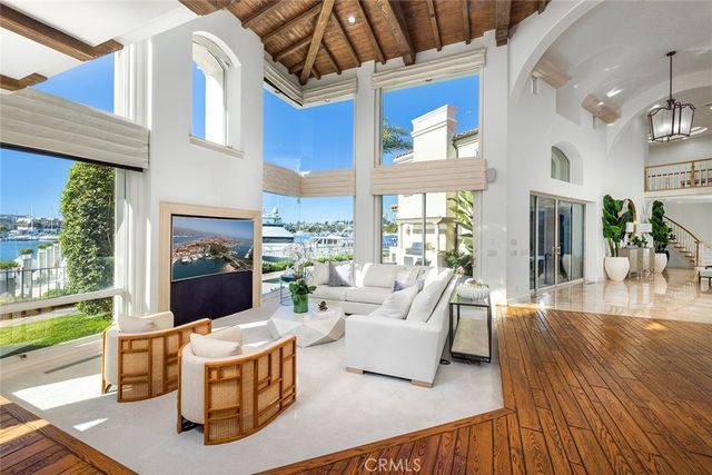 a living room with fireplace furniture and a floor to ceiling window