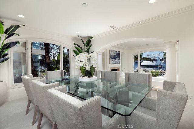 a view of a dining room with furniture wooden floor and windows