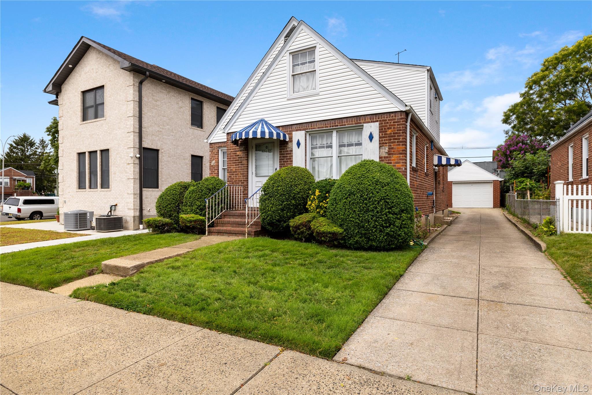 254-07 84th Road Floral Park, NY 11001 - Photo 1 of 1 a front view of a house with a yard