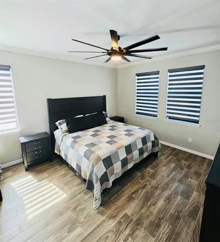 a bedroom with a bed and a ceiling fan
