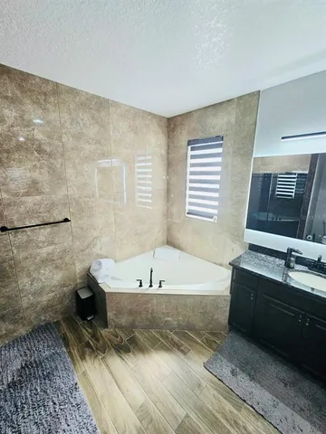 a bathroom with a bathtub sink and toilet