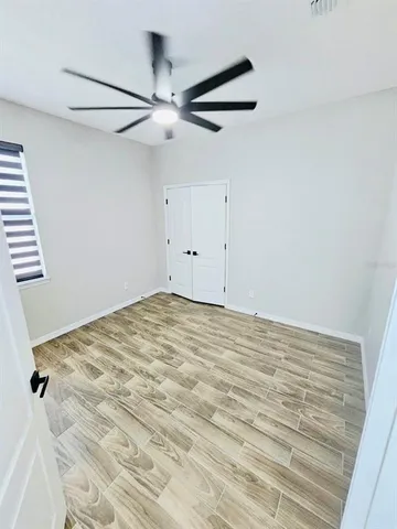 a view of a room with wooden floor