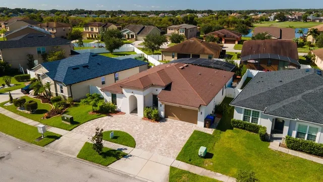 an aerial view of multiple houses with a yard