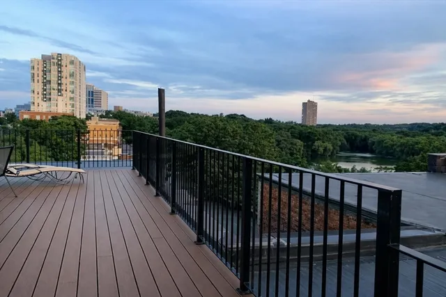 a balcony with wooden floor and city view