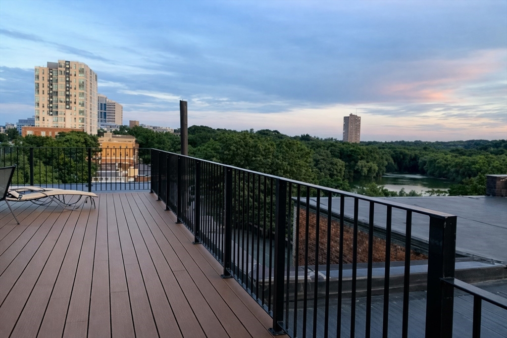a balcony with wooden floor and city view