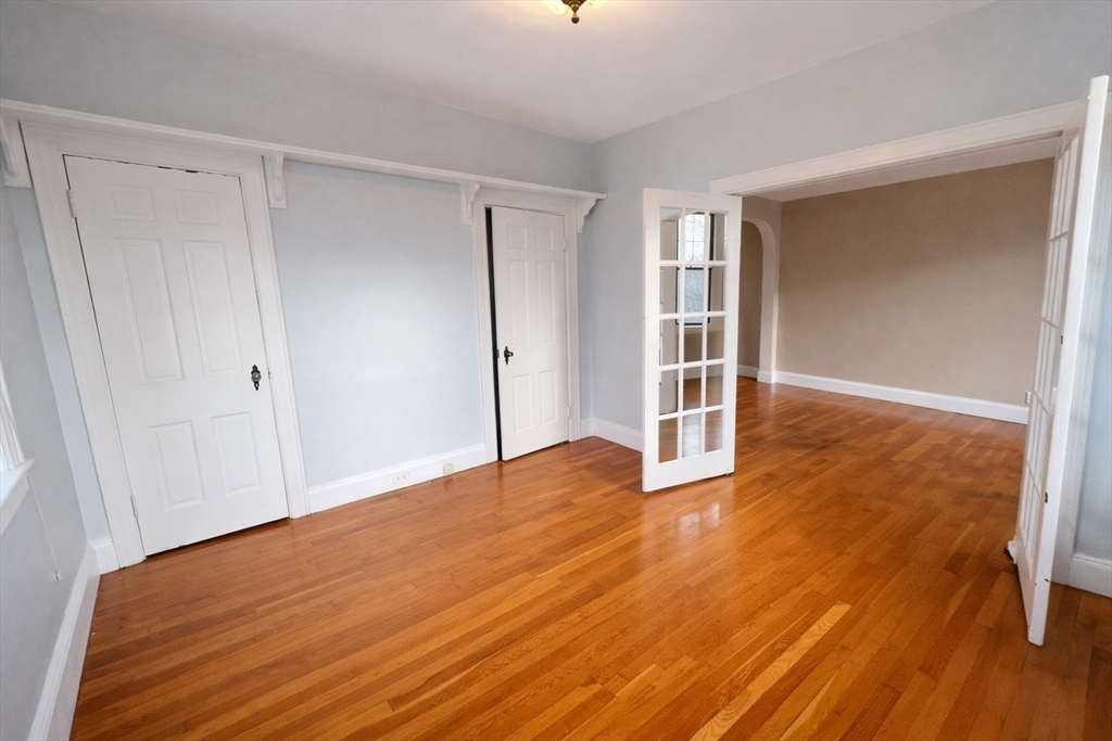 10 Jamaicaway, Unit 23 Boston, MA 02130 - Photo 11 of 14 a view of an empty room with wooden floor