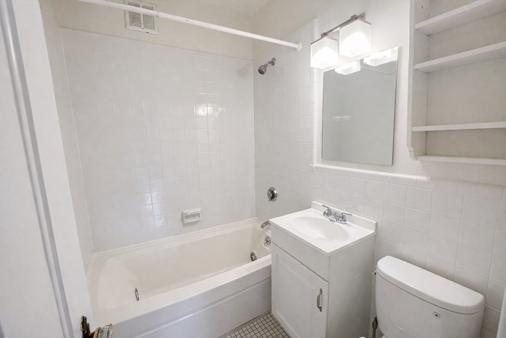 10 Jamaicaway, Unit 23 Boston, MA 02130 - Photo 14 of 14 a bathroom with a bathtub a shower a toilet and sink
