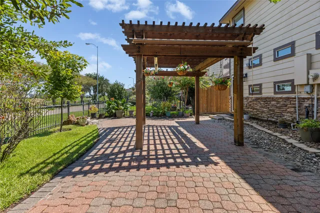 a view of a patio with table and chairs and wooden fence