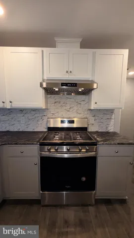 a stove top oven sitting inside of a kitchen