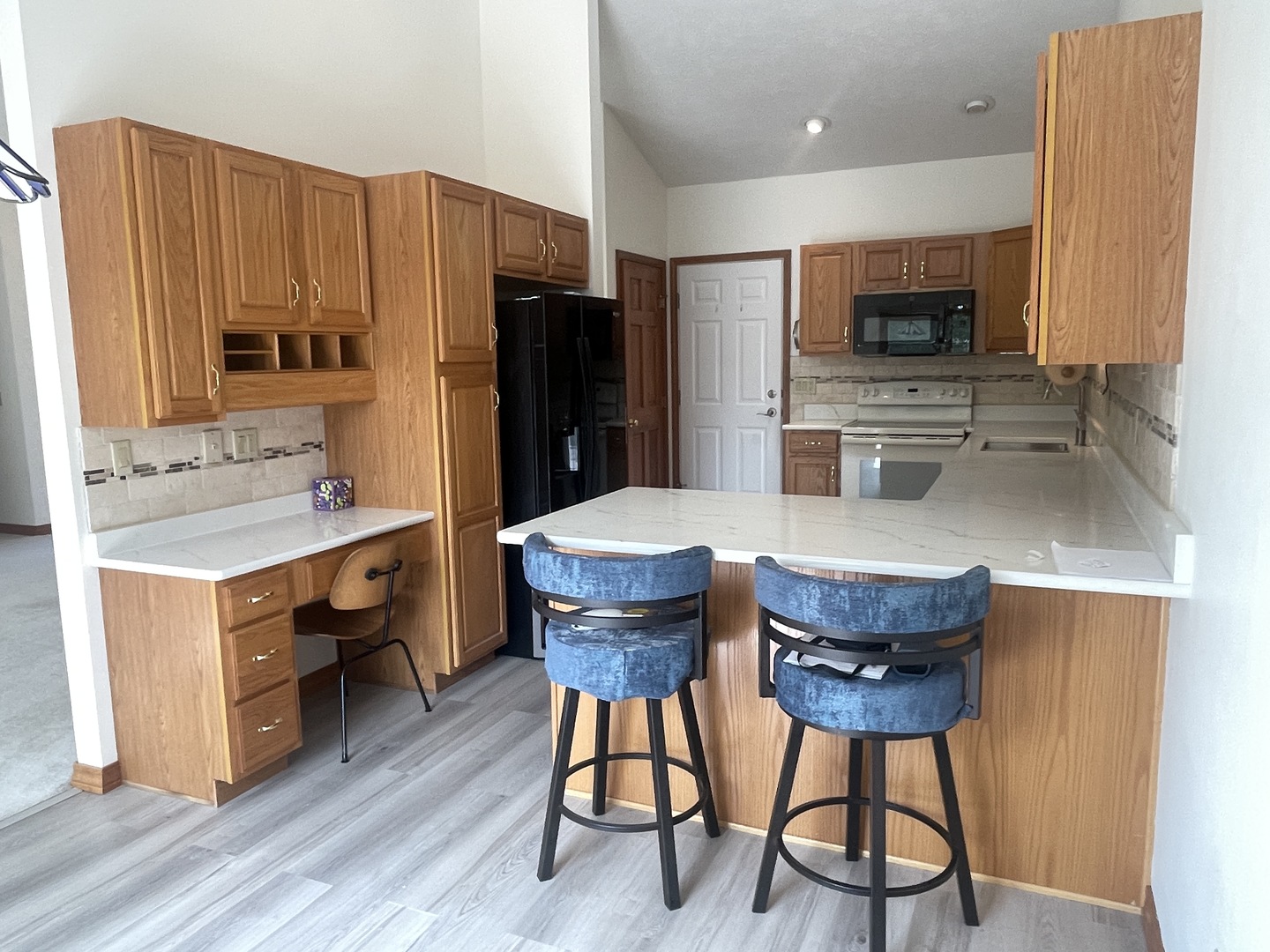 205 Field Court Normal, IL 61761 - Photo 2 of 22 a kitchen with a table chairs refrigerator and microwave