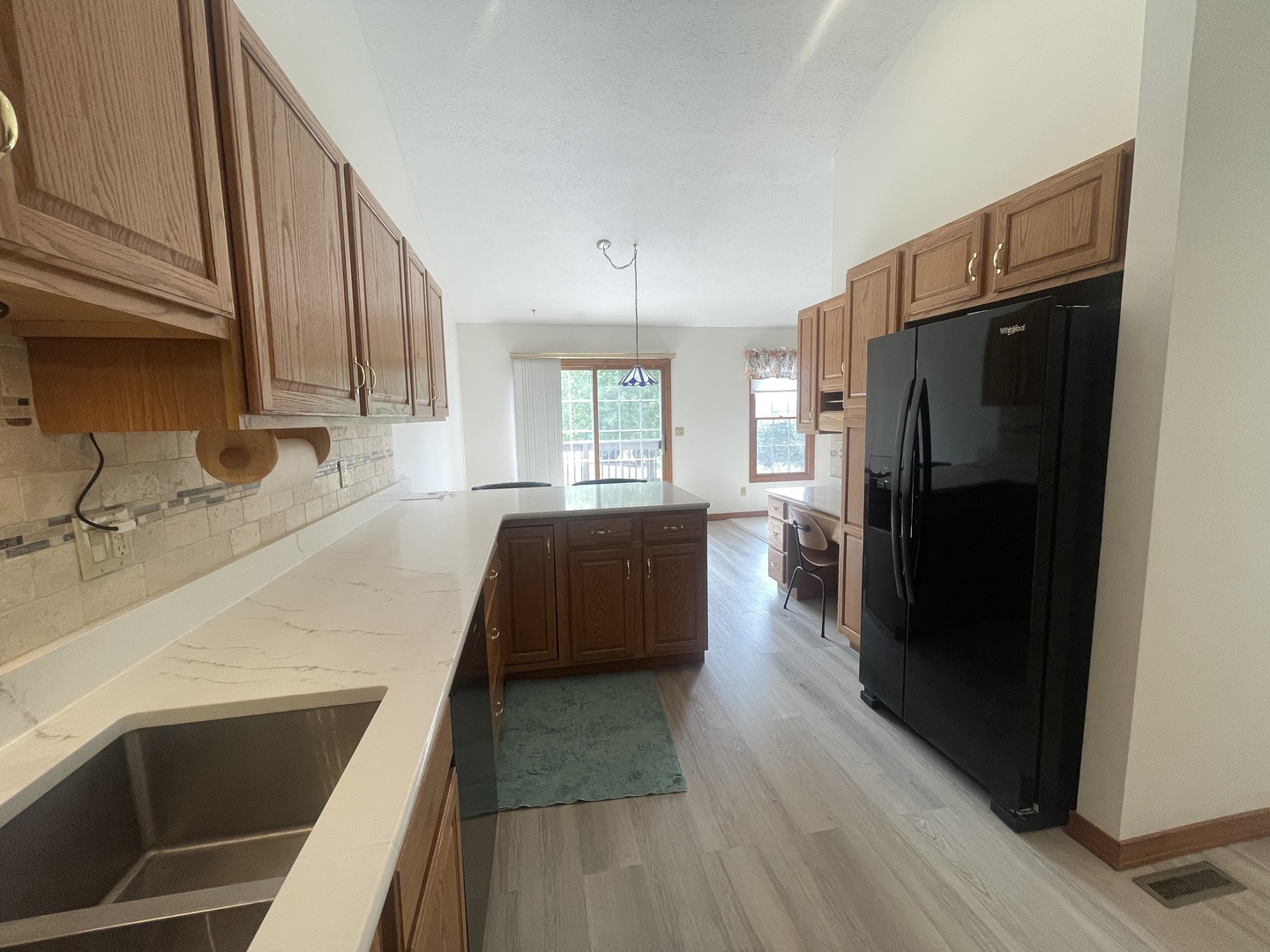 205 Field Court Normal, IL 61761 - Photo 3 of 22 a kitchen with a sink a refrigerator a window and wooden floor