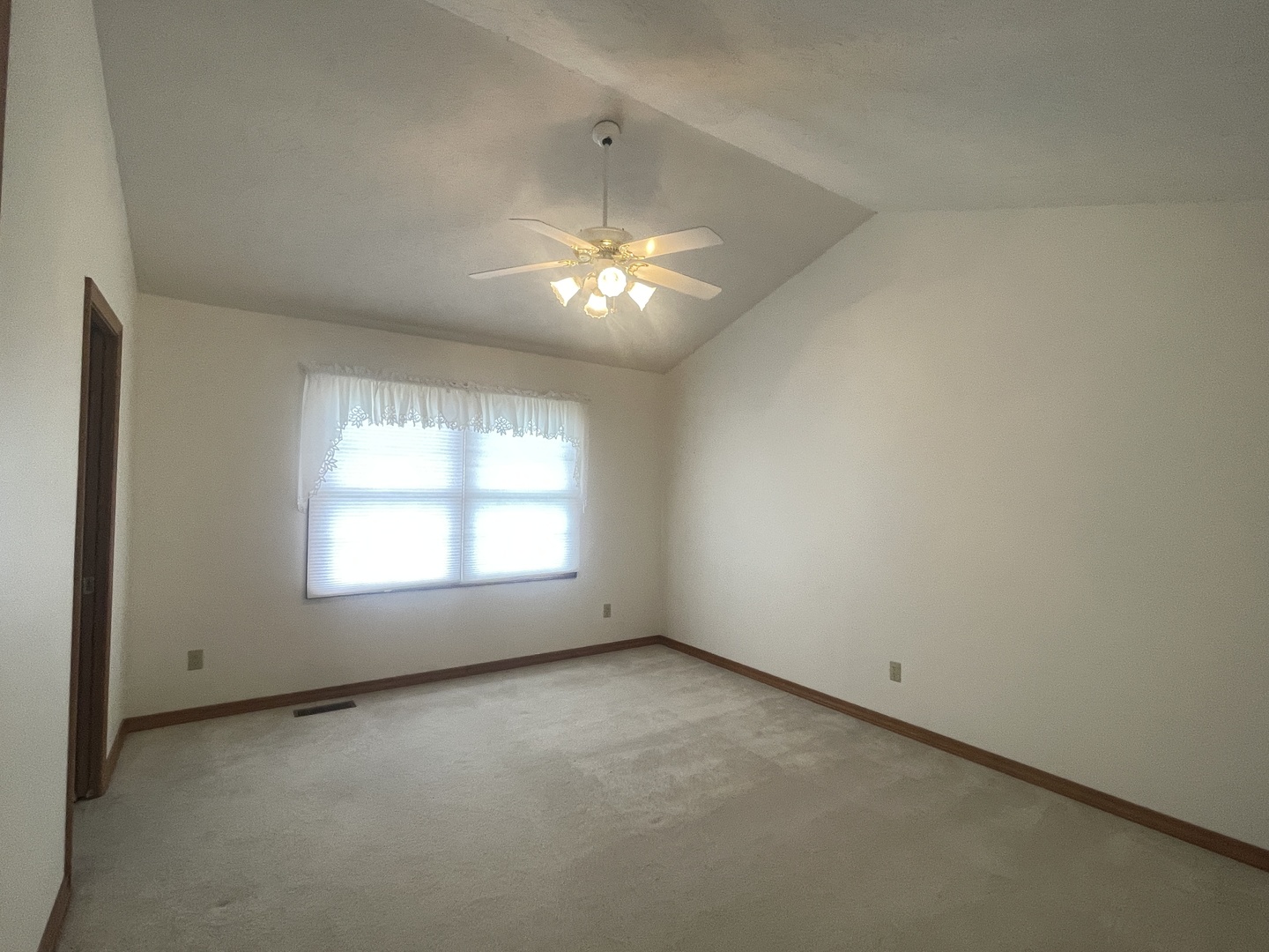 205 Field Court Normal, IL 61761 - Photo 6 of 22 an empty room with a window and a ceiling fan