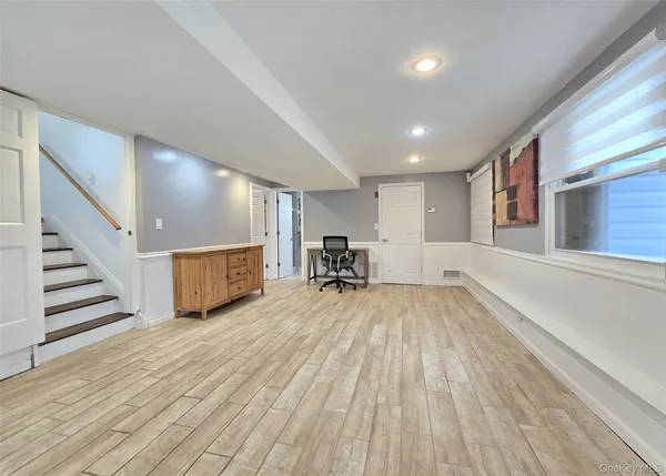 a view of a living room a dining room with wooden floor and furniture