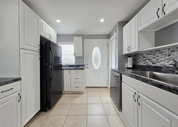 a kitchen with a refrigerator and a sink