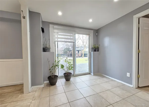 a view of entryway with window and front door