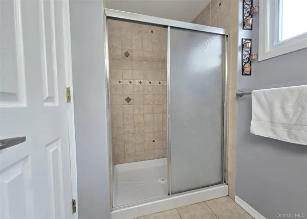 a bathroom with a glass shower door