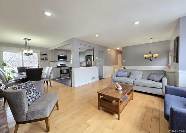 a living room with furniture and kitchen view