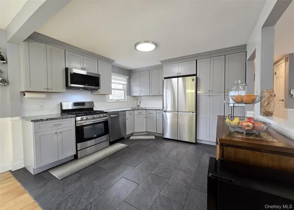 a kitchen with a refrigerator stove and microwave