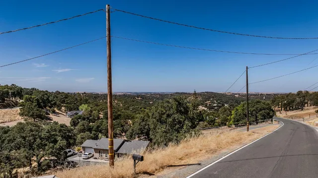 an aerial view of a house with a yard and large trees
