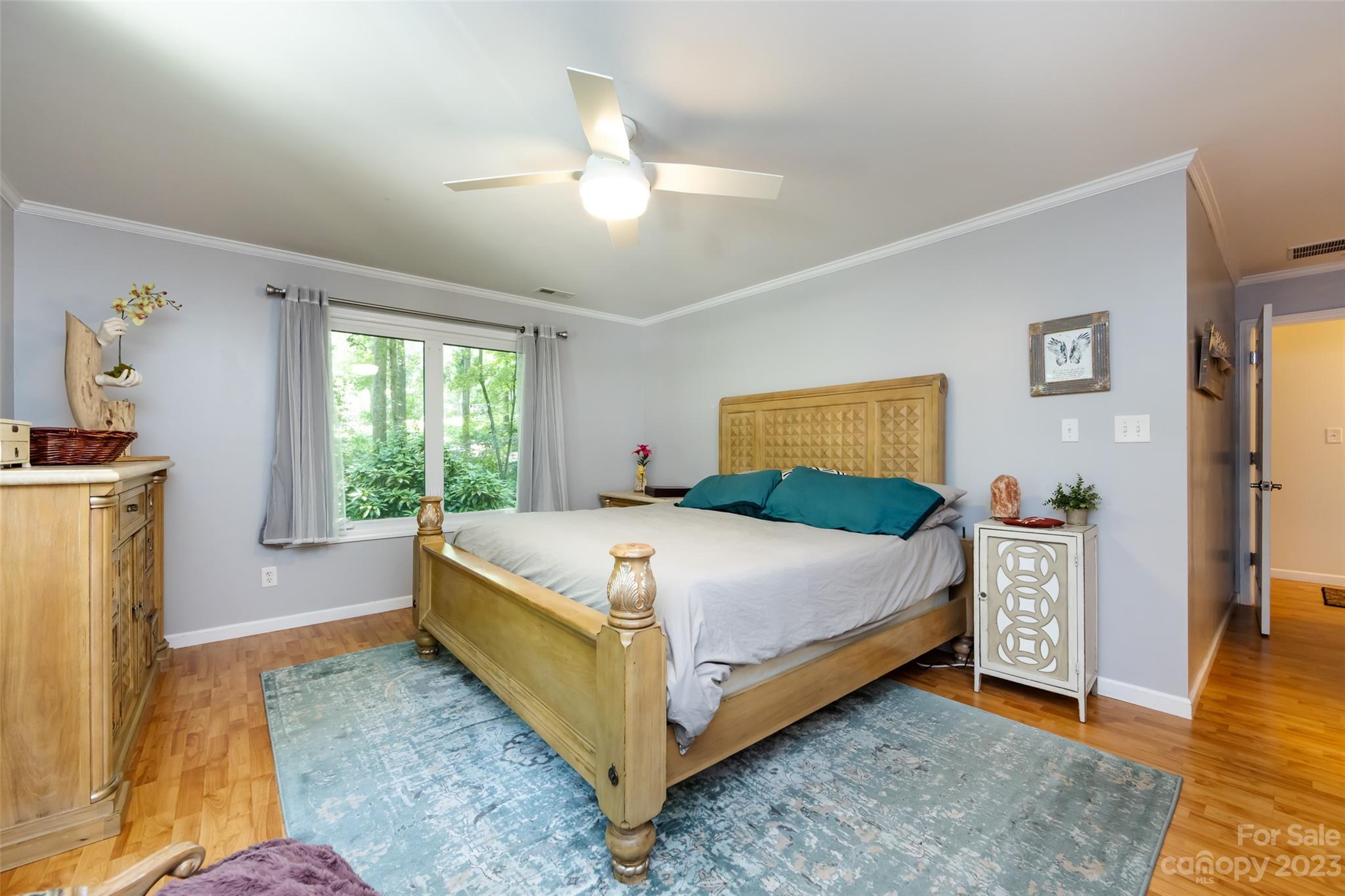 9441 Man O War Road Indian Land, SC 29707 - Photo 12 of 45 a bedroom with a large bed and a chandelier
