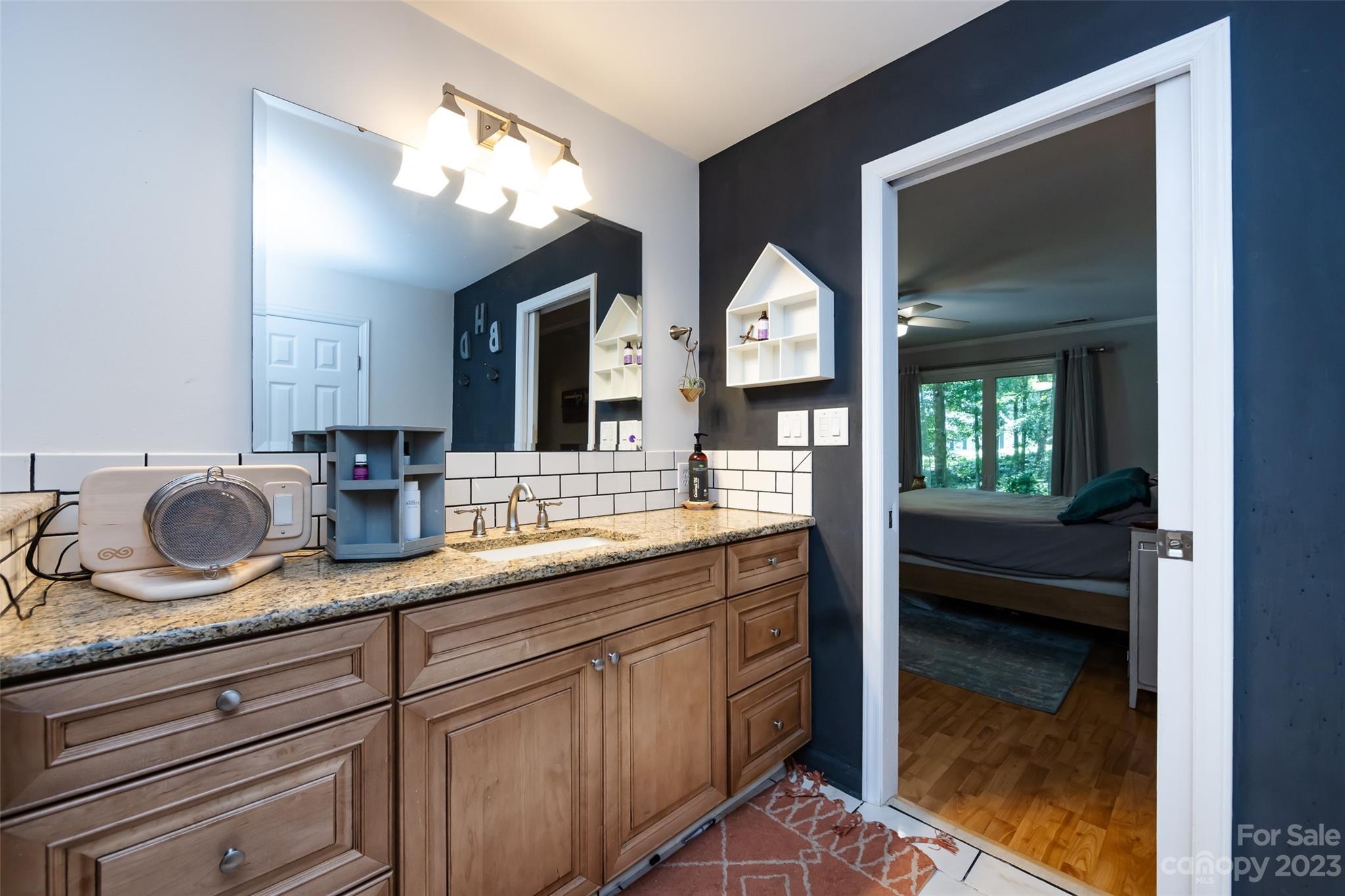9441 Man O War Road Indian Land, SC 29707 - Photo 15 of 45 a en suite bathroom with double vanity and a mirror