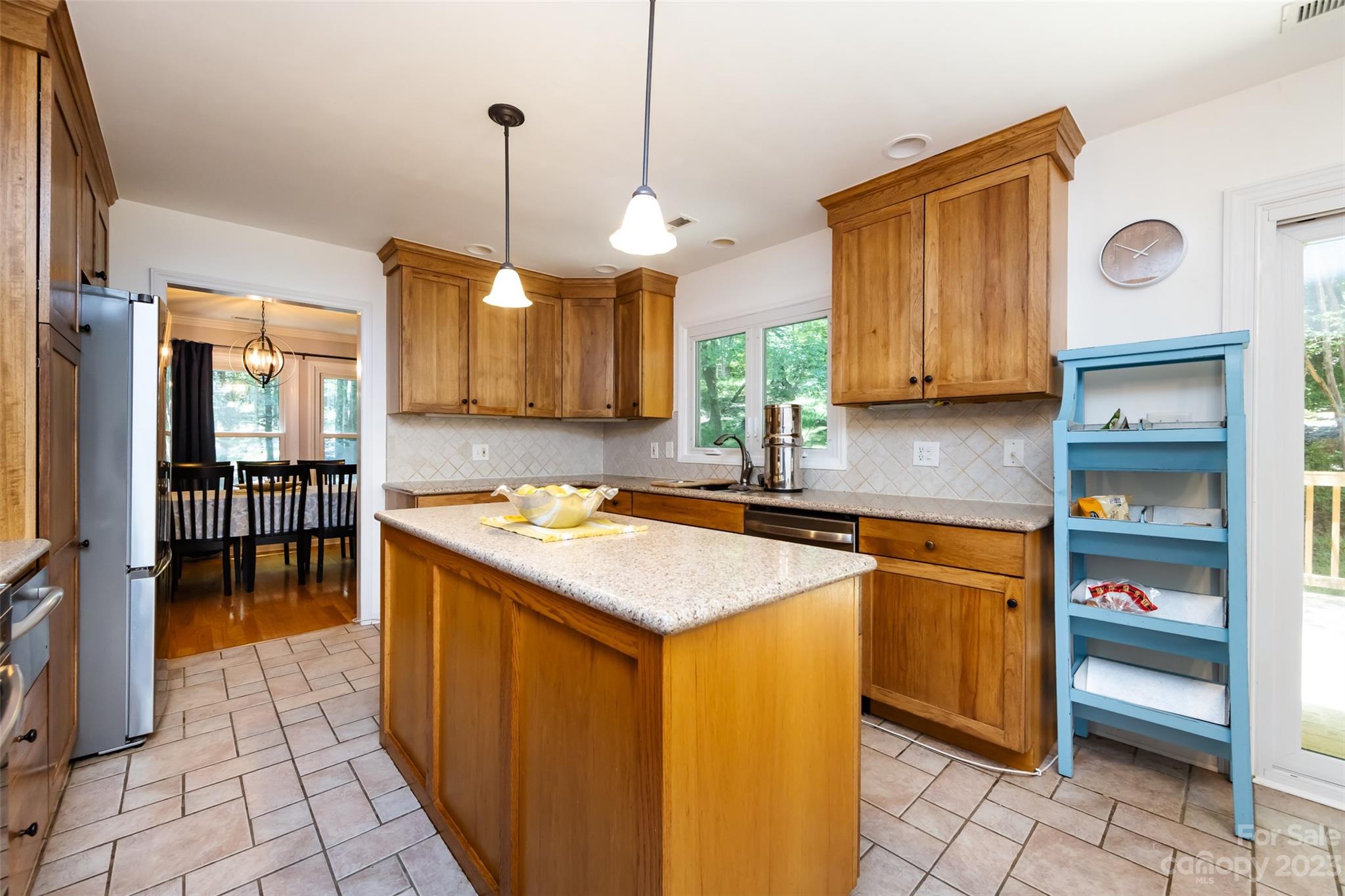 9441 Man O War Road Indian Land, SC 29707 - Photo 20 of 45 a kitchen with stainless steel appliances granite countertop a sink a stove and a wooden floors