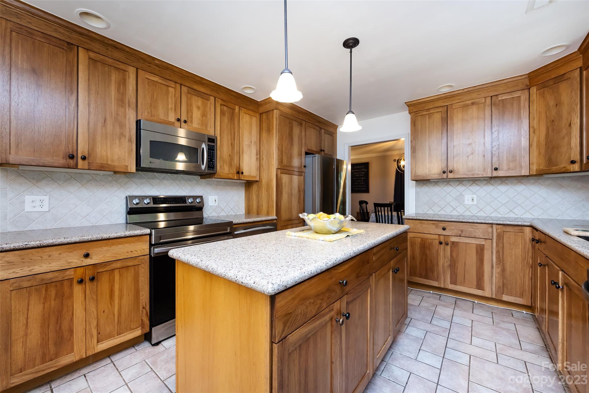 9441 Man O War Road Indian Land, SC 29707 - Photo 21 of 45 a kitchen with stainless steel appliances granite countertop a sink stove and refrigerator