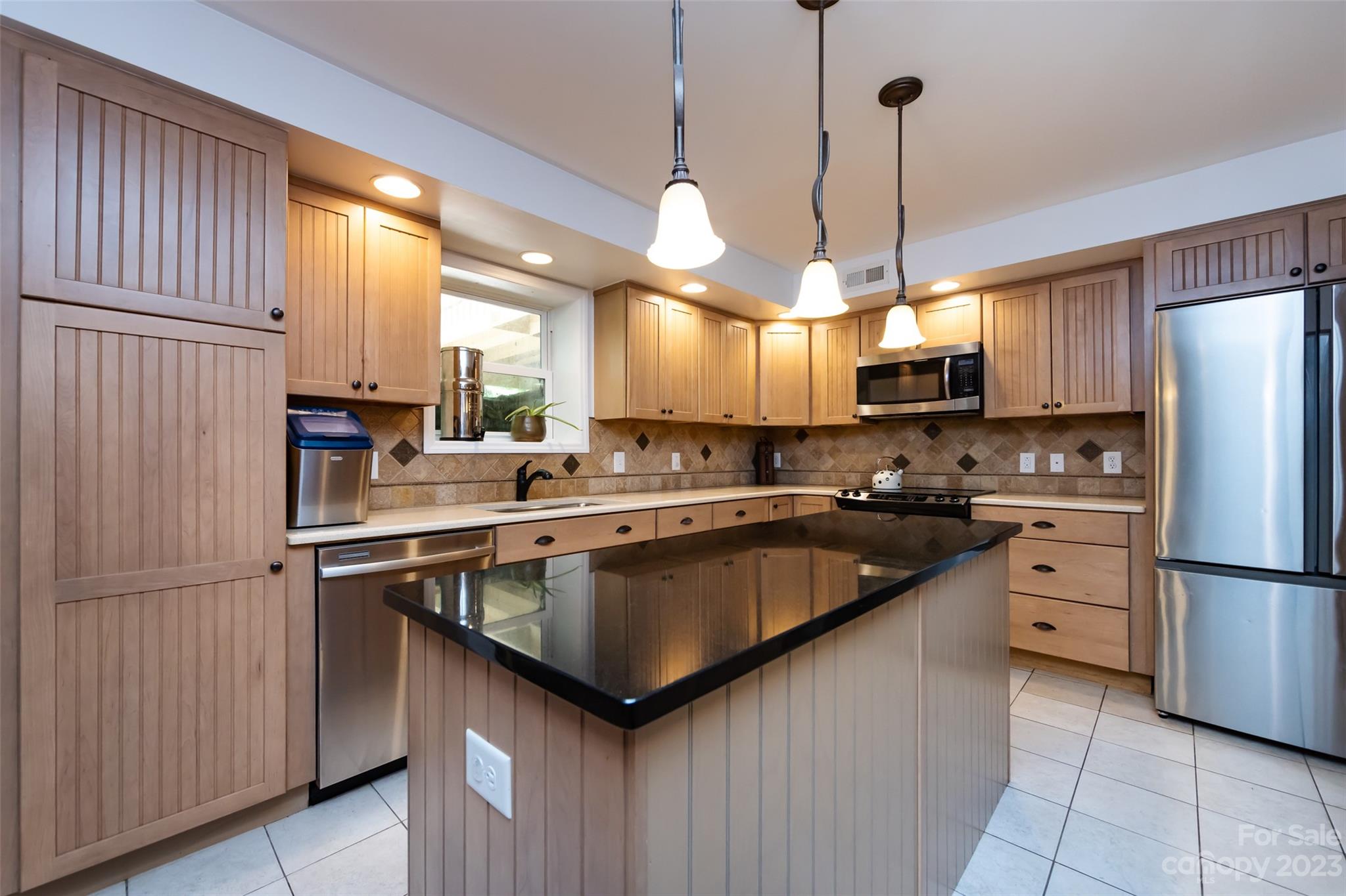 9441 Man O War Road Indian Land, SC 29707 - Photo 7 of 45 a kitchen with stainless steel appliances granite countertop a refrigerator a sink dishwasher a stove and a refrigerator with wooden floor
