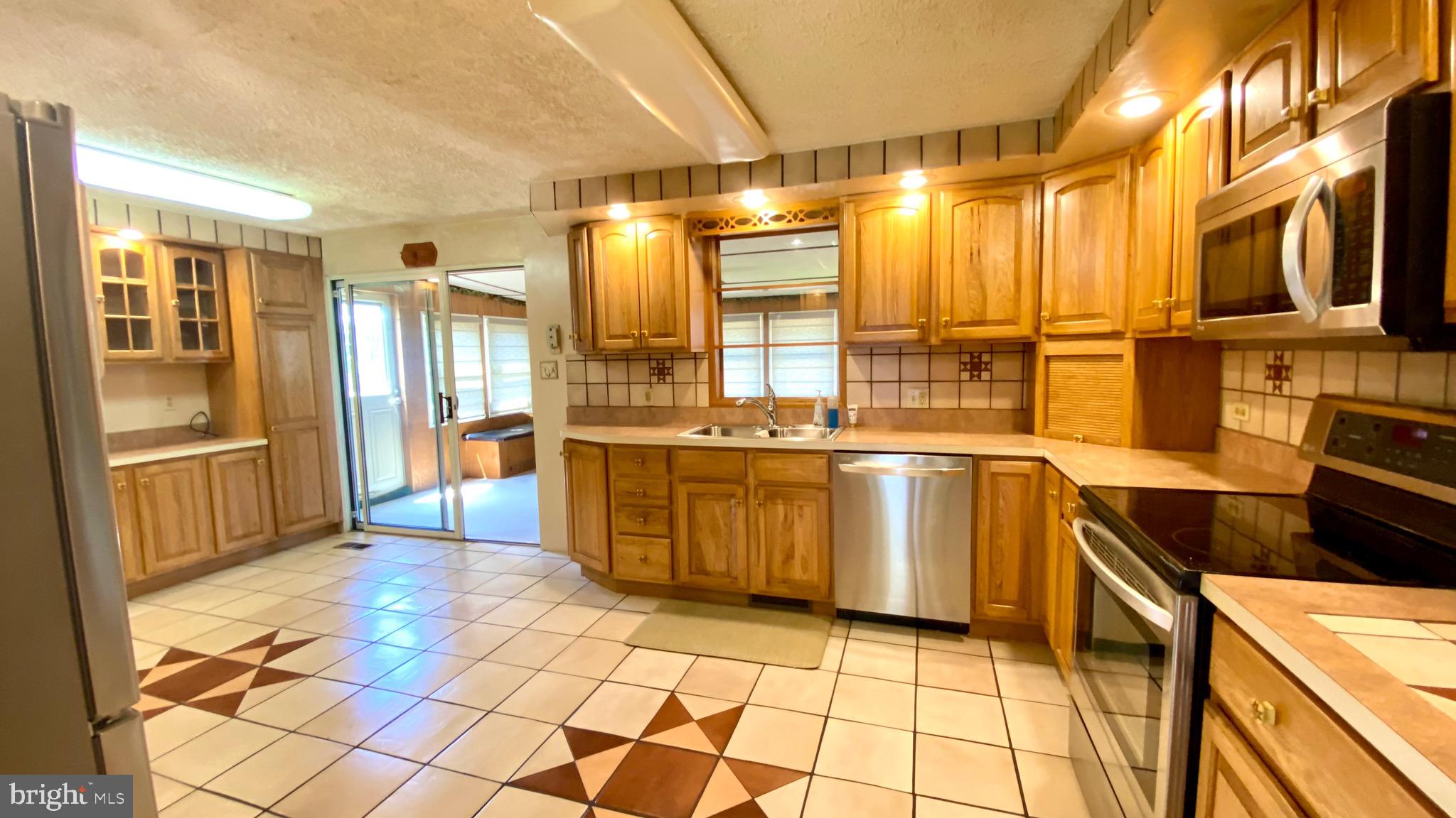 4 Old Sound Road Joppa, MD 21085 - Photo 4 of 20 a kitchen with stainless steel appliances granite countertop a stove a sink and a refrigerator
