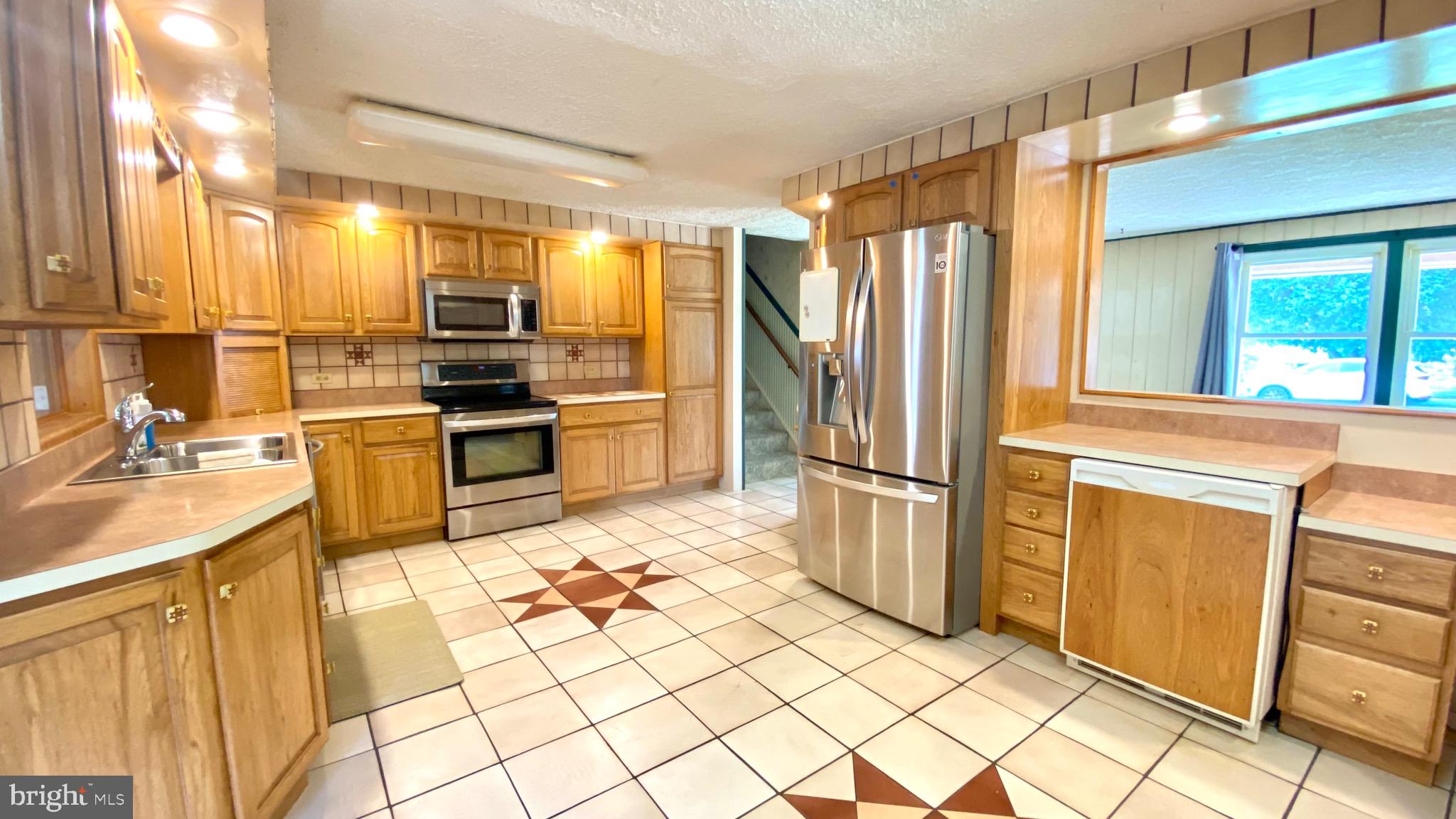 4 Old Sound Road Joppa, MD 21085 - Photo 6 of 20 a kitchen with stainless steel appliances granite countertop a refrigerator and a sink