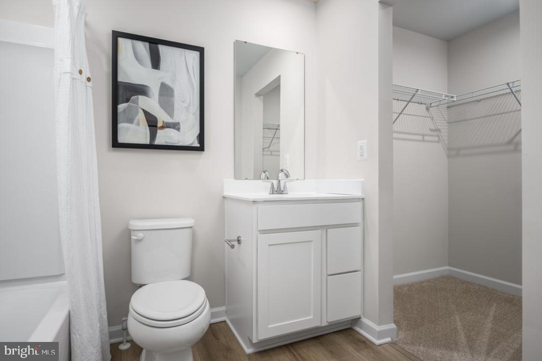 1180 West Walnut Road, Unit 9 Vineland, NJ 08360 - Photo 13 of 17 a bathroom with a toilet sink and mirror