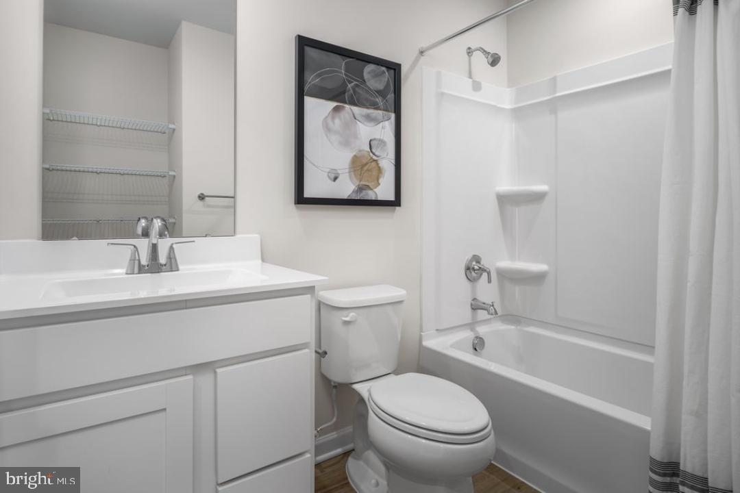 1180 West Walnut Road, Unit 9 Vineland, NJ 08360 - Photo 17 of 17 a bathroom with a toilet sink and mirror